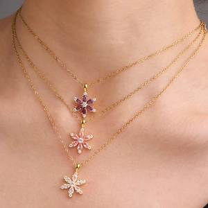 Three-layer gold flower necklaces with pink purple and white zircon stones on model