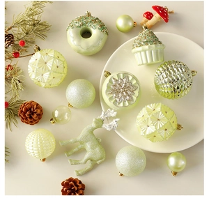 Detail of Christmas tree ornaments including pale green reindeer and cupcake shapes on a plate