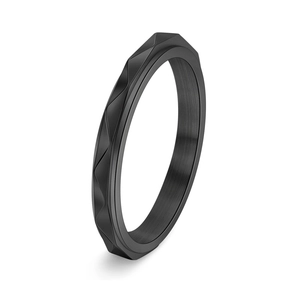 Macro view of matte black stainless steel ring with faceted geometric wave patterns