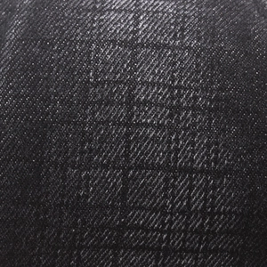 Macro texture of black twill denim fabric with vintage checked pattern for newsboy caps