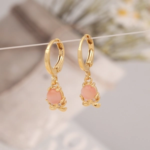 Golden octopus earrings with pink stones and zircon accents in a detailed hanging view