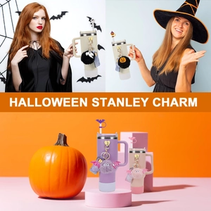 Close-up of Halloween tumbler accessories with ghost charms and colorful pompom pendant