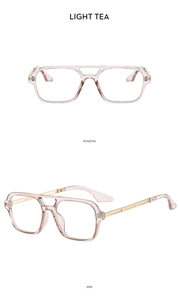 Detail view of vintage double-bridge aviator sunglasses with light tea lenses and gold arms