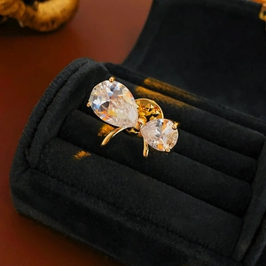 Detail of a gold-plated butterfly brooch with sparkling white pear-shaped rhinestones
