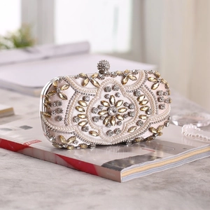 Detailed macro view of luxury evening clutch bag with champagne satin and crystal beadwork