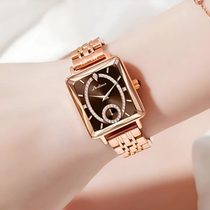Detail view of square rose gold watch with brown diamond-set dial on a female wrist