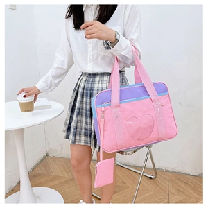 Detail of pink and purple canvas tote bag with heart-shaped clear window and coin pouch
