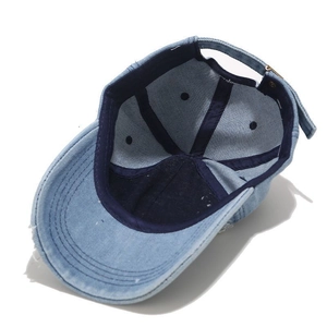 Vintage light blue washed denim baseball cap with distressed finish and metal buckle