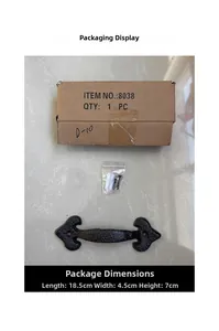 Macro view of vintage black cast iron door handle set with mounting screws and brown box