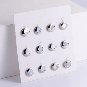 Minimalist silver-edged shell stud earrings set with lustrous pearl-like textures