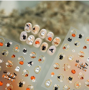 Detail of Halloween nail stickers with gold outlines, pumpkins, and black cats