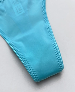 Macro detail of bright blue ice silk fabric with zigzag stitching and elastic texture