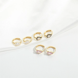 Three pairs of gold drop earrings with white black and purple enamel and clear zircon