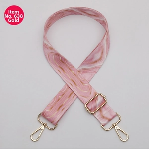 Detail view of pink marble patterned bag strap with durable gold metal hardware