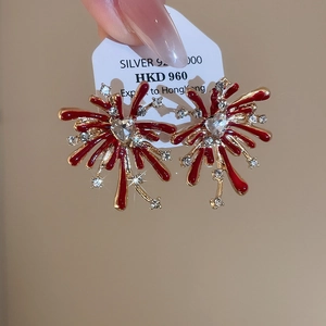 Detail of red enamel firework earrings with silver 925 heart-shaped crystal center