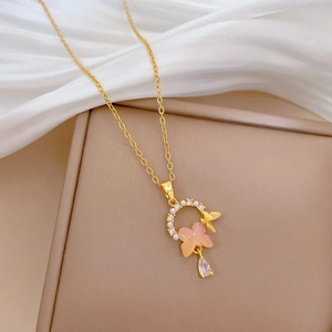 Titanium butterfly pearl necklace with crystal pendant on elegant silk background
