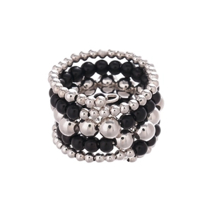Multi-layer layered ring with silver metal beads and black faux pearls on white background
