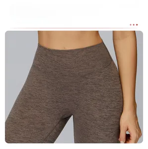 Detail of high waisted compression yoga pants with textured grey-brown fabric and tummy control