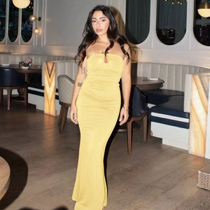 Detail of yellow bodycon tube maxi dress featuring ruched fabric and slim fit silhouette