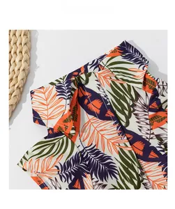 Detail of tropical leaf print pet shirt featuring a classic collar and woven fabric