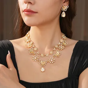 Parure de bijoux vintage dorée avec papillon, perles et goutte d'eau champagne