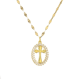 Close-up of golden cross pendant necklace with sparkling cubic zirconia crystals