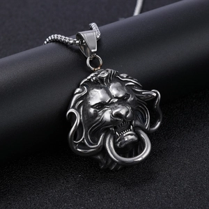 Detail of a 3D lion head pendant in antique silver finish on a black column stand