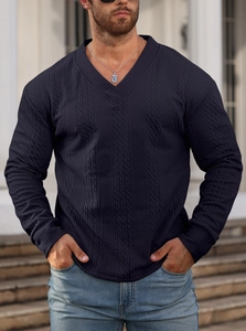 Detailed cable-knit texture and V-neckline of a dark blue men's knitted sweater