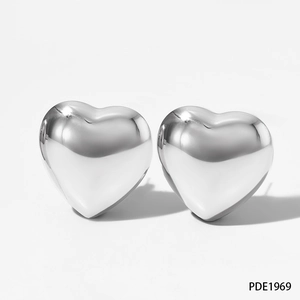 Close-up of high-polished hollow heart earrings with 3D design on a clean white background