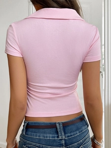 Vue arrière d'un haut polo court rose ajusté montrant la texture en maille douce