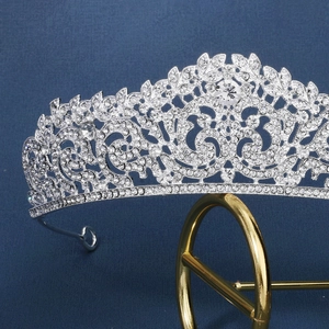 Close-up of silver bridal crown with intricate leaf patterns and sparkling rhinestones