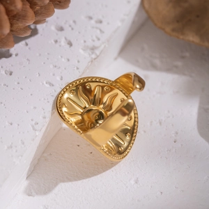 Retro 18K gold plated sun face embossed stainless steel open ring on a stone base