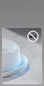 Detail of white ceramic pet bowl with anti-ant water moat design for neck protection