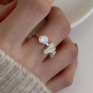 Minimalist S925 sterling silver ring featuring iridescent zircon stones worn on hand