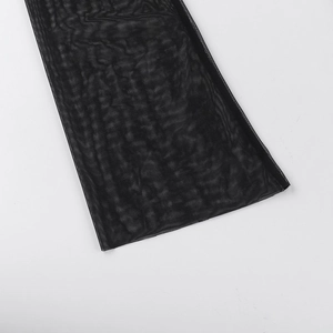 Detailed macro shot of high-quality black mesh fabric texture and stitching on the dress hem