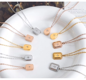 Close-up of geometric starburst zircon pendants in gold, silver, and rose gold finishes