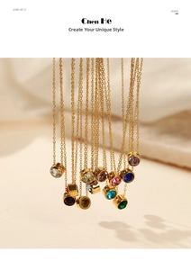 Detailed view of layered gold necklaces with colorful round gemstone pendants