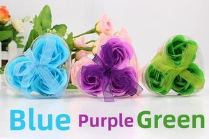 Detailed view of heart-shaped gift boxes with three rose-shaped soap flowers in blue and purple