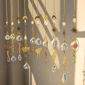 Golden brass butterfly suncatcher with raw crystal prisms creating rainbow light reflections