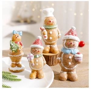 Detail of four resin gingerbread man figurines with frosted texture for Christmas decor