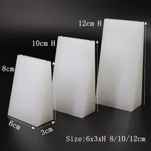 Three-piece set of white frosted acrylic trapezoid display stands for jewelry pendants