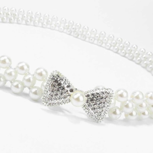Elegant double-row pearl waist belt with rhinestone bow decoration on white background