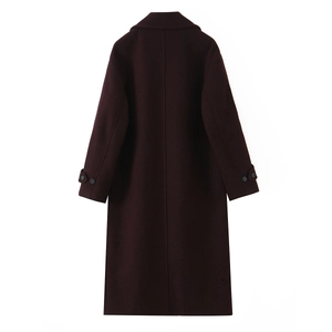 Detail view of the back seam and adjustable buttoned cuffs on this wine red wool coat