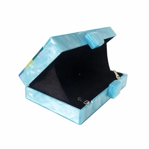 Blue marble acrylic evening clutch with metal chain and black lining in a half-open view