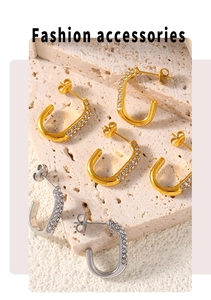 Detailed view of U-shaped gold and silver earrings with micro-paved rhinestones