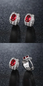 Detailed views of silver hoop earrings with oval red stone and pave-set crystals