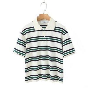 Detailed view of striped polo shirt's piqué cotton texture and brand neck label