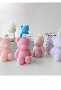 Macro detail of cute bear shaped scented candles in various pastel colors with wicks
