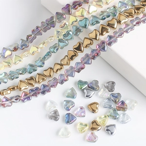 Macro shot of 8mm heart-shaped glass beads in diverse iridescent and metallic finishes