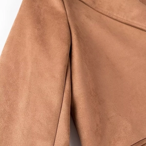 Detail of premium brown faux suede fabric texture on a long double-breasted coat